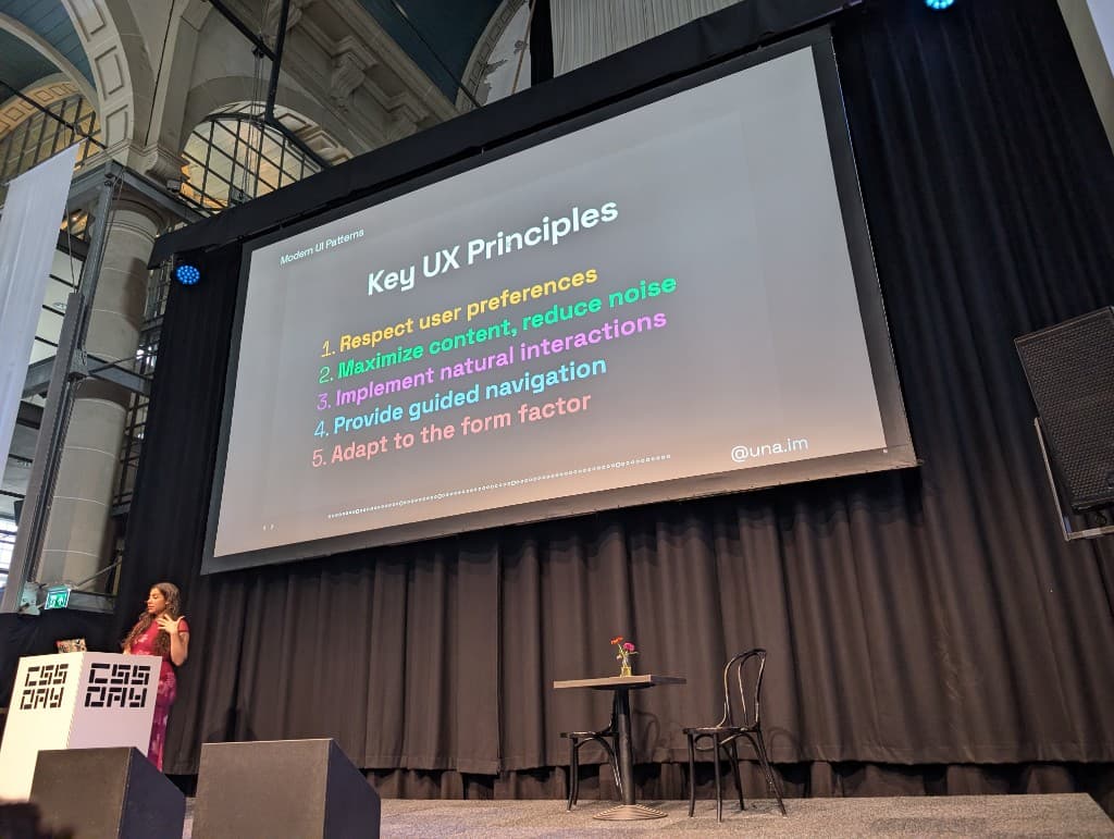 Una Kravets on stage at CSS Day 2026 showing her slide on Key UX Principles